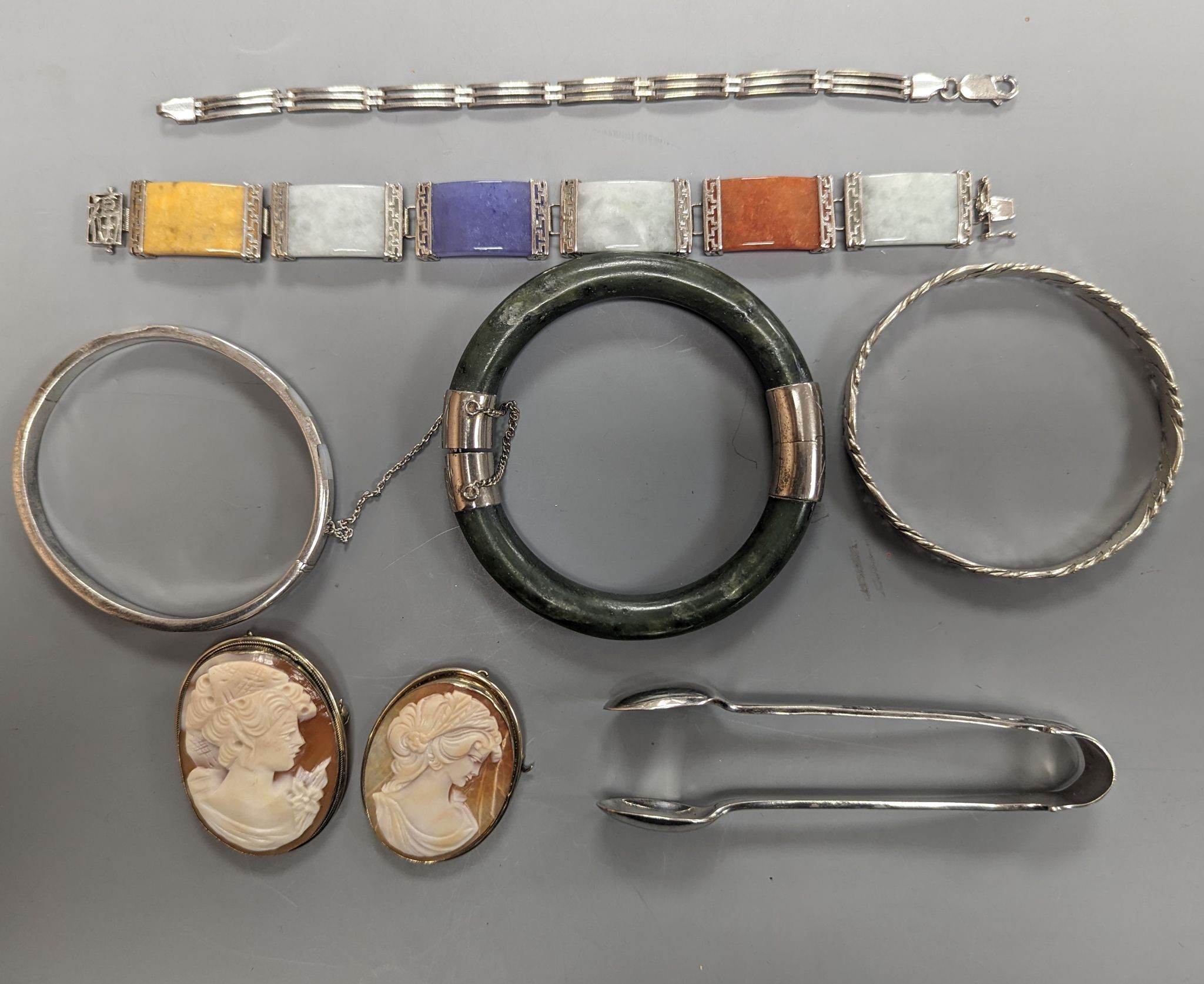 A 925 and hardstone set bracelet, 19.7cm, one other bracelet, two cameo shell brooches, three assorted bangles and a pair of sugar tongs.